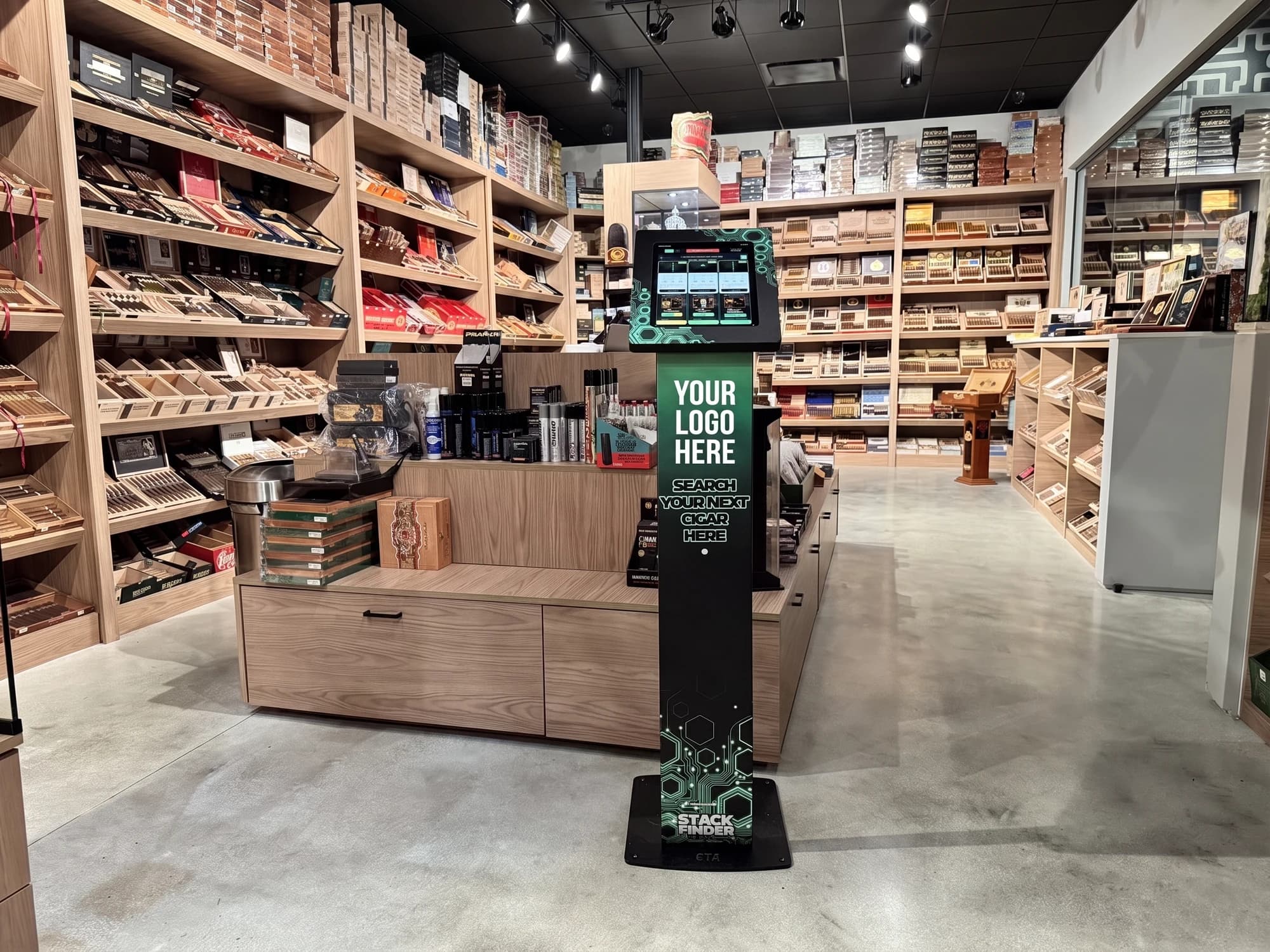 The Stack Finder stand installed on a cigar lounge floor, with the branding panel left blank for the retailer's own logo